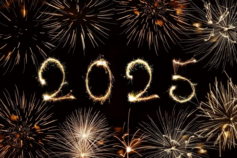 2025 written with sparkles and fireworks