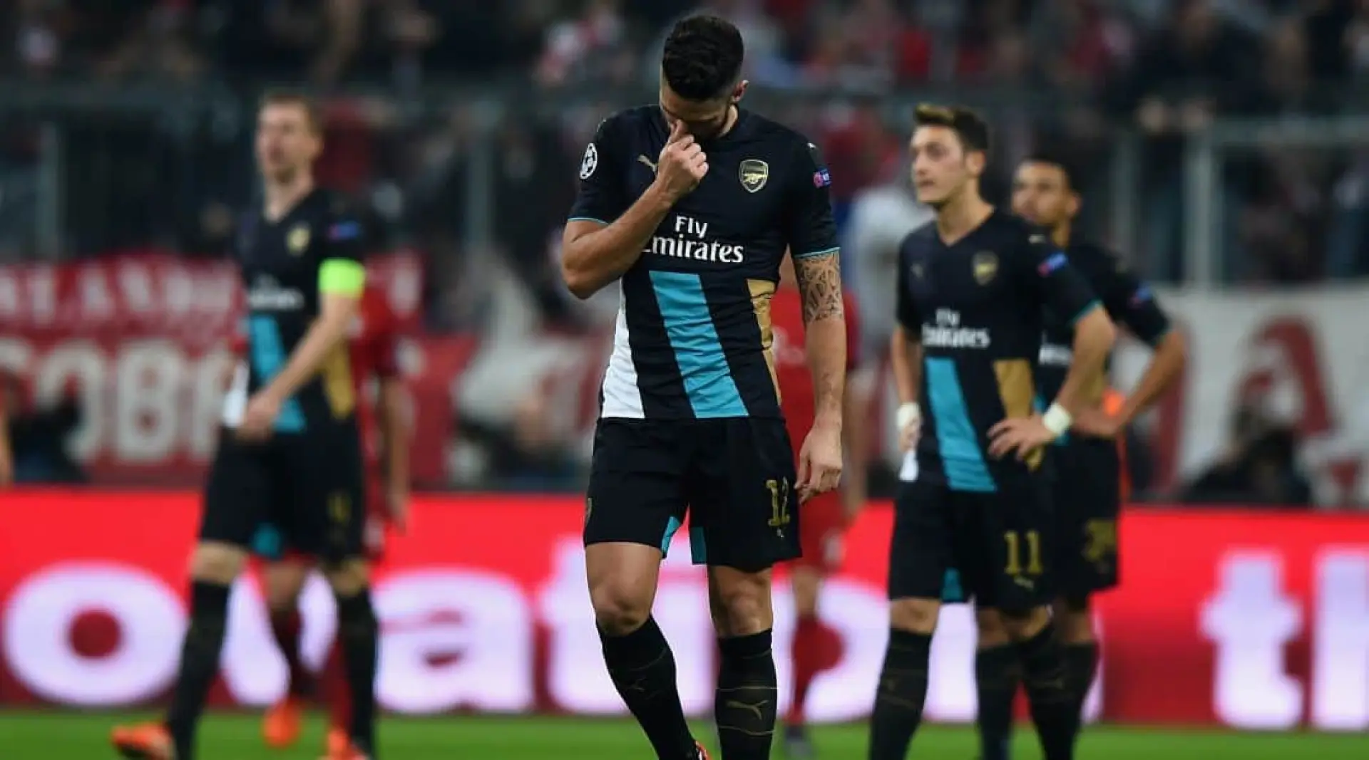 Olivier Giroud and his Arsenal teammates react to defeat at Bayern Munich