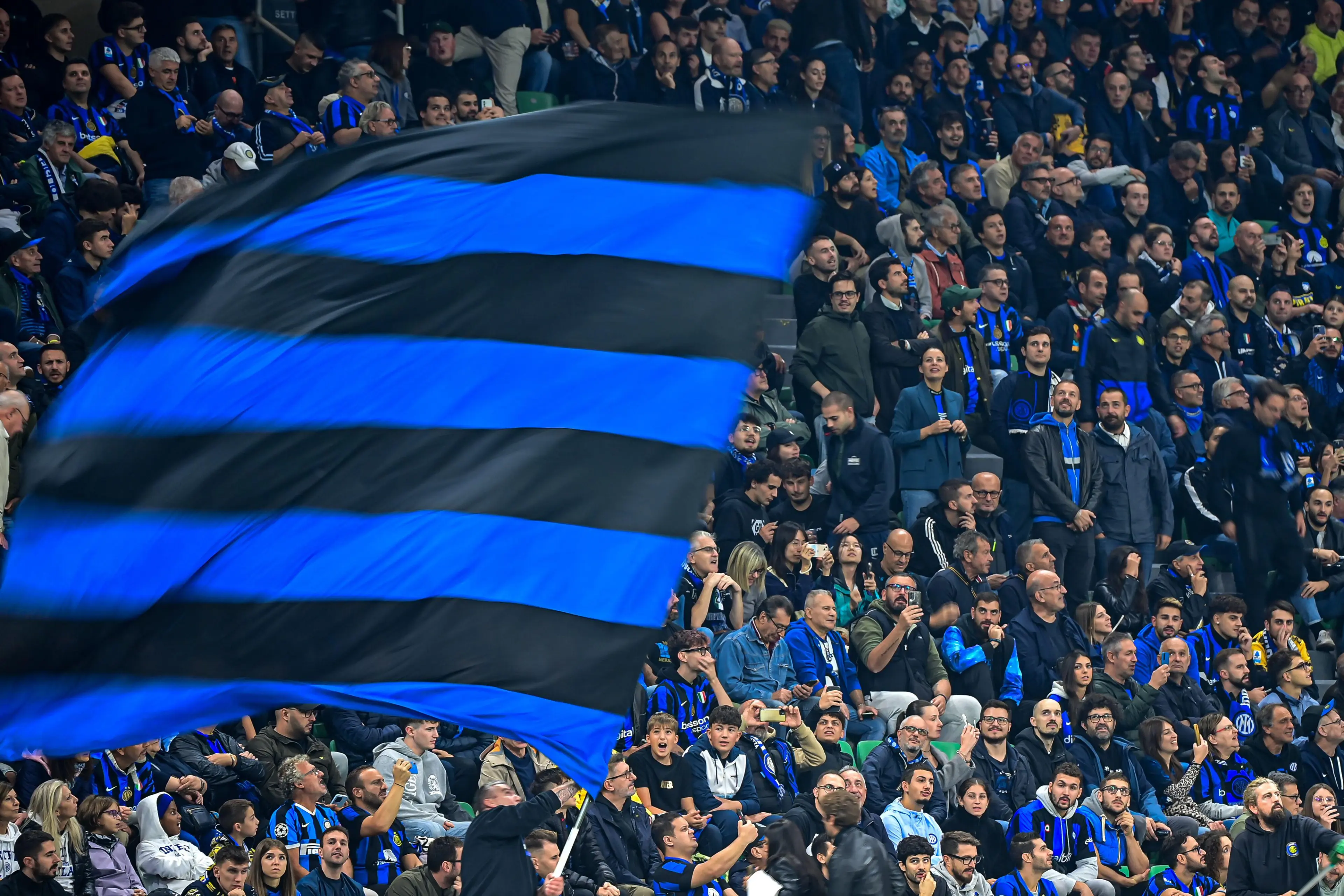 Inter Milan's supporters wave flags during the UEFA Champions League football match Inter Milan vs Crvena Zvezda Beograd ( Red Star ) at San Siro Stadium
