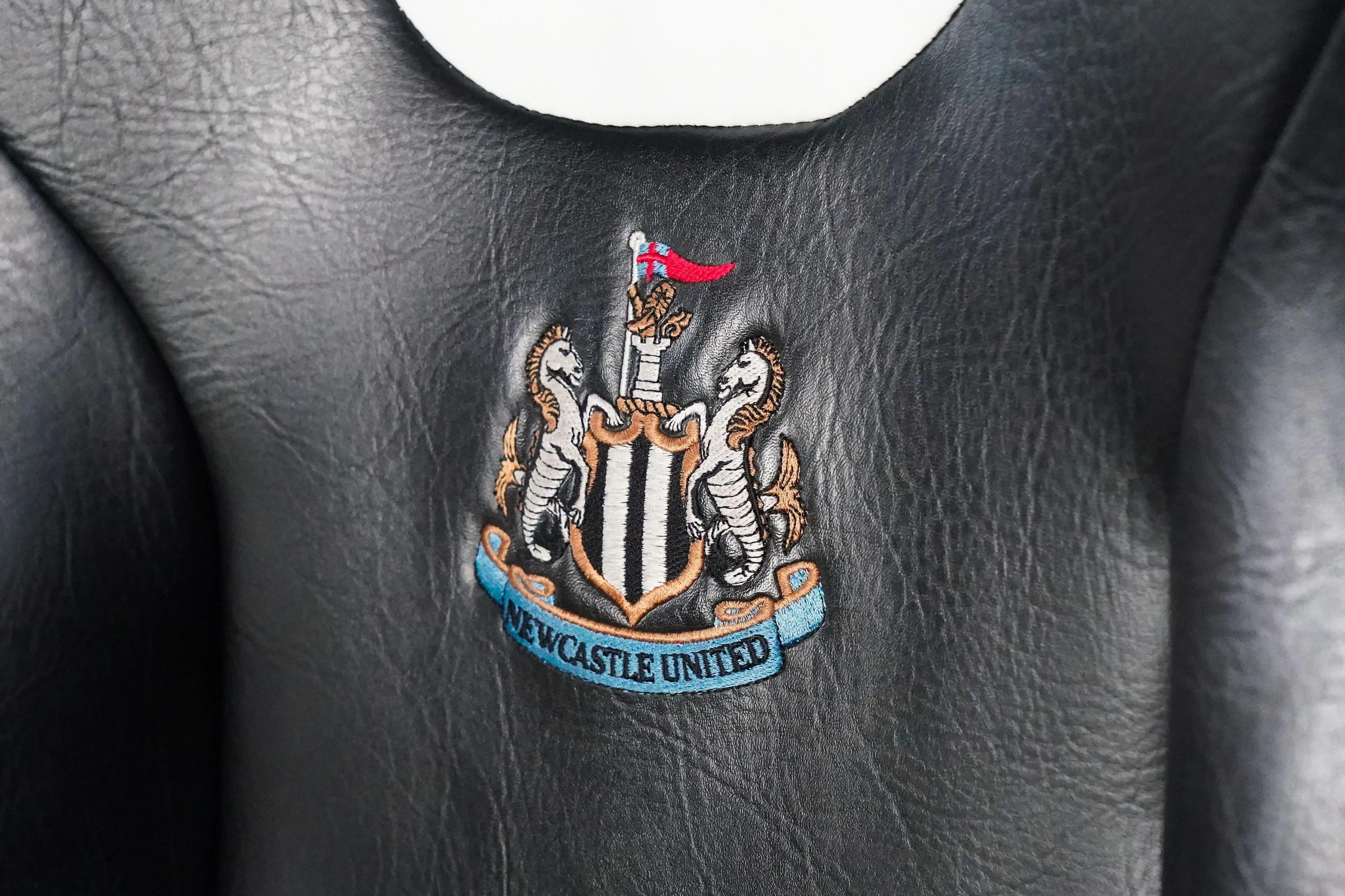 Newcastle, UK. 13th Dec, 2023. Embroidered Newcastle badge on seat on the subs bench during the Newcastle United FC v AC Milan UEFA Champions League Group F match at St.James' Park, Newcastle, United Kingdom on 13 December 2023