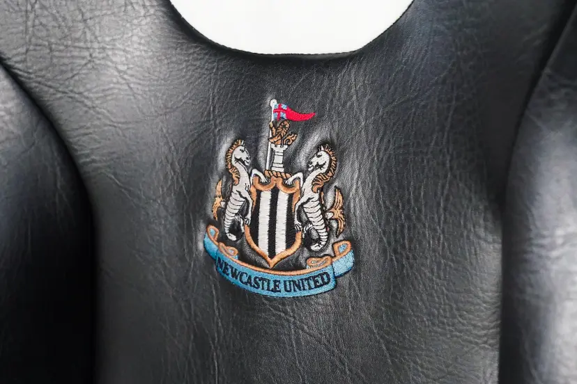 Newcastle, UK. 13th Dec, 2023. Embroidered Newcastle badge on seat on the subs bench during the Newcastle United FC v AC Milan UEFA Champions League Group F match at St.James' Park, Newcastle, United Kingdom on 13 December 2023