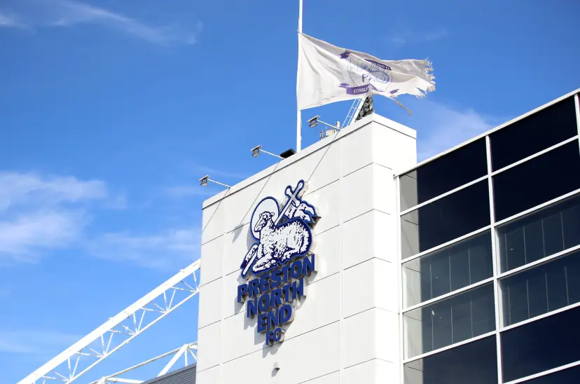 A general view of a Preston North End logo with a flag flying at half mast outside the stadium ahead of the Sky Bet Championship match at Deepdale Stadium, Preston